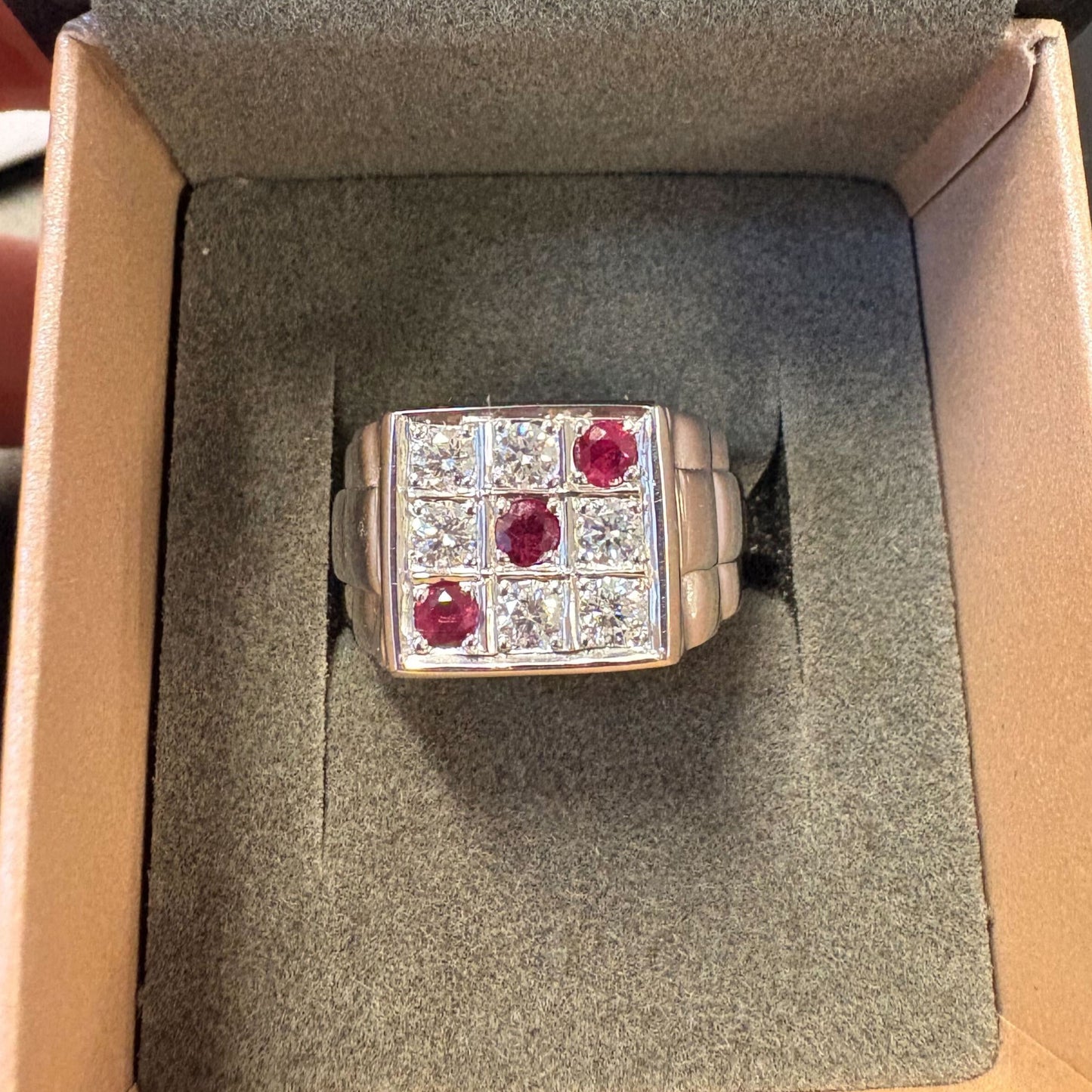 9ct white gold ring with six diamonds SI clarity, H-J color for a total carat weight of 0.50ct and three medium-grade red rubies for a total of 0.30ct. Total ring weight of 12.9 gr. Size K.