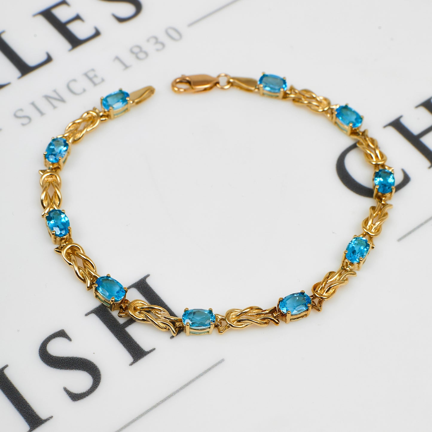 Pre-Owned 9ct Gold Blue Topaz & Knot Link Bracelet