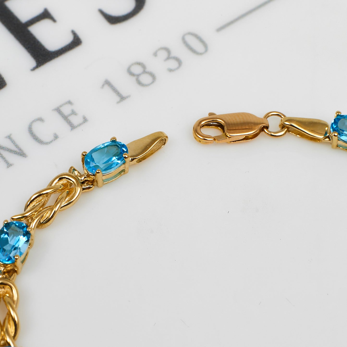 Pre-Owned 9ct Gold Blue Topaz & Knot Link Bracelet