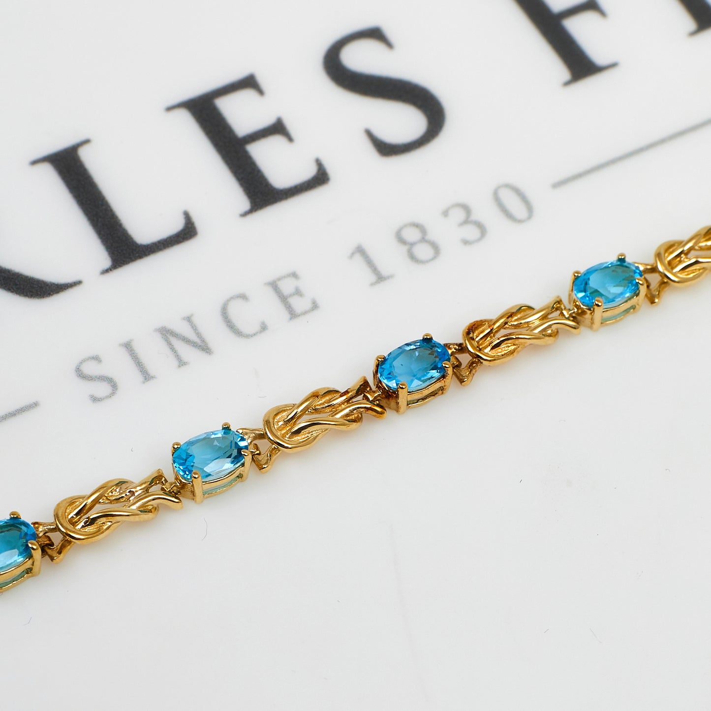 Pre-Owned 9ct Gold Blue Topaz & Knot Link Bracelet