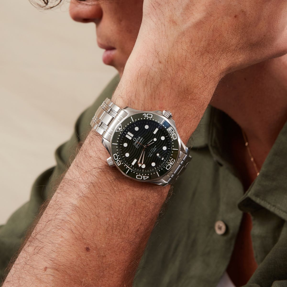 Omega Seamaster Professional 300m green dial on steel bracelet worn outdoors