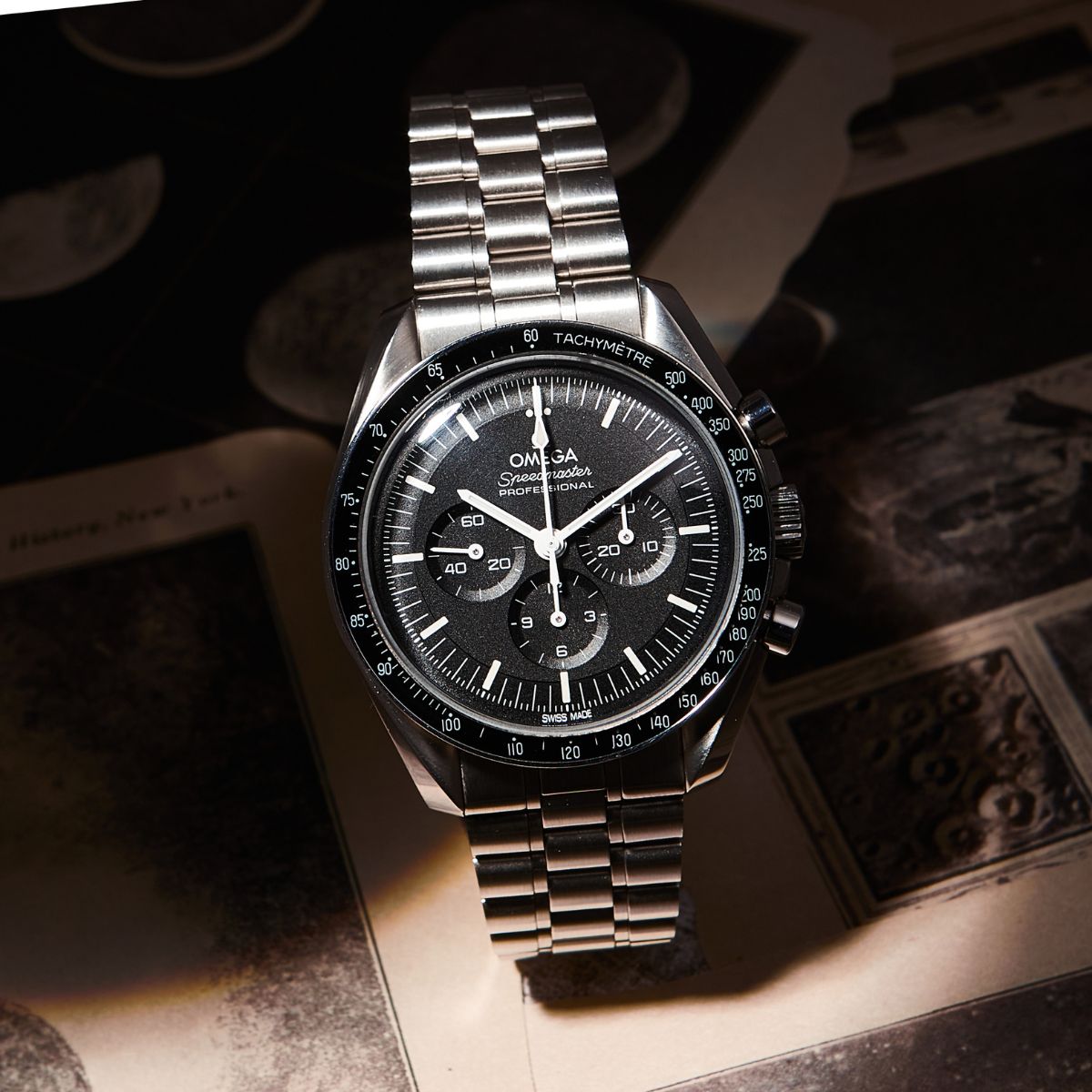 Omega Speedmaster Professional Moonwatch on steel bracelet on vintage photographs
