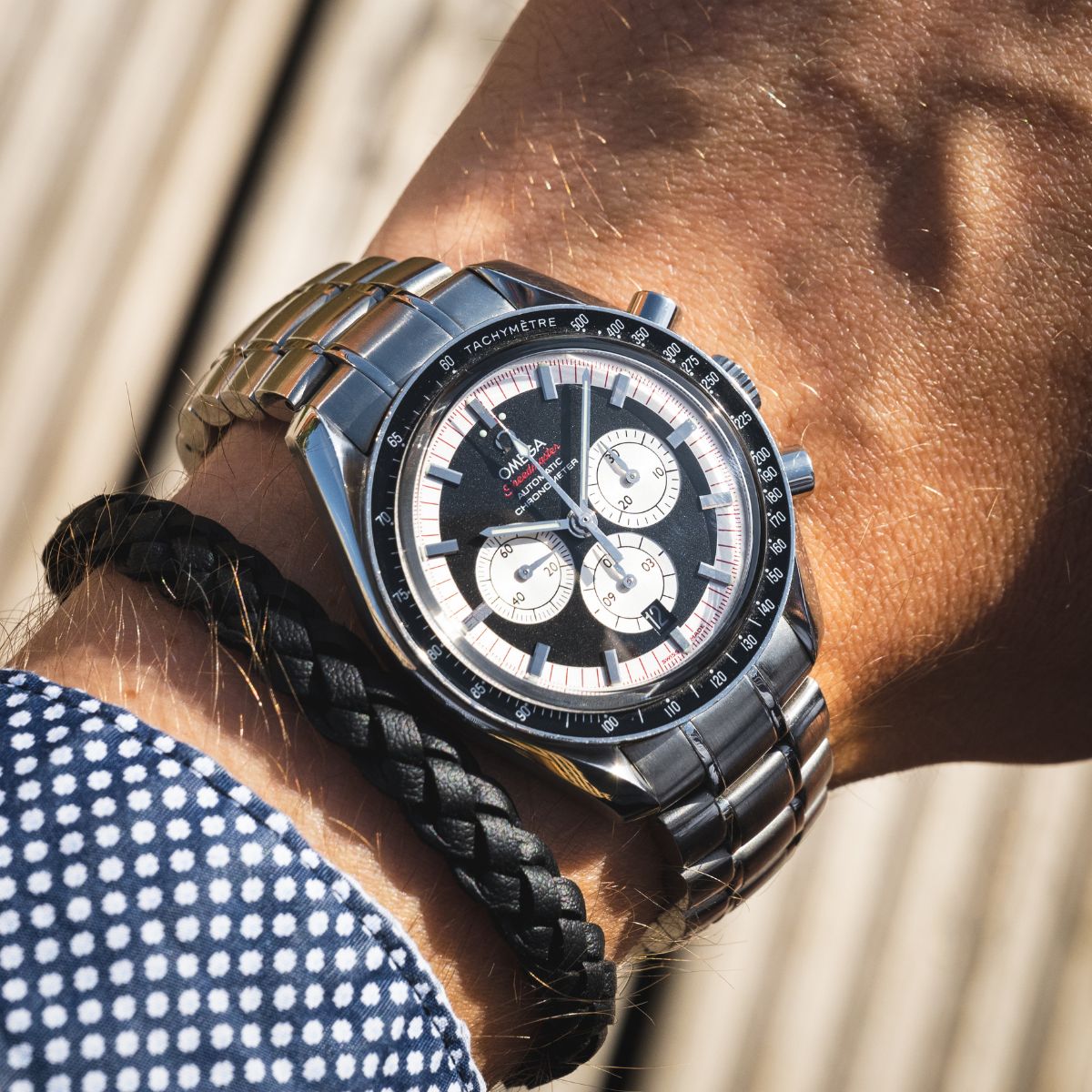 Omega Speedmaster Racing chronograph on steel bracelet on wrist outdoors