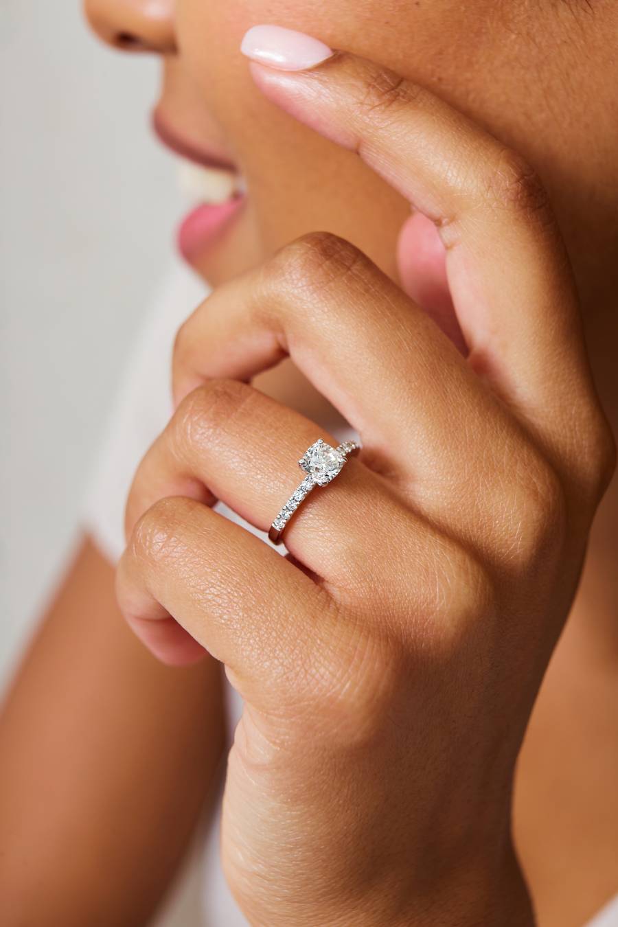 white woman wearing white gold engagement ring
