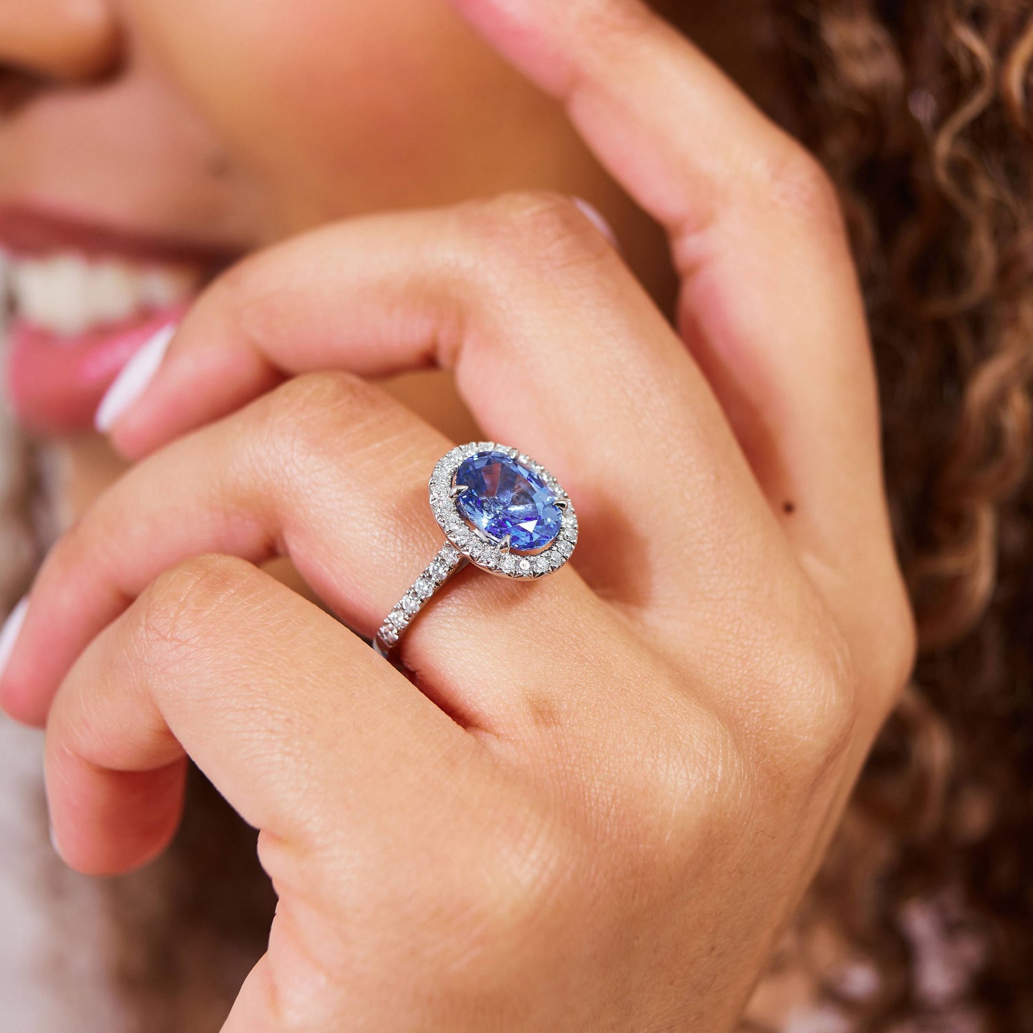 woman wearing sapphire engagement ring
